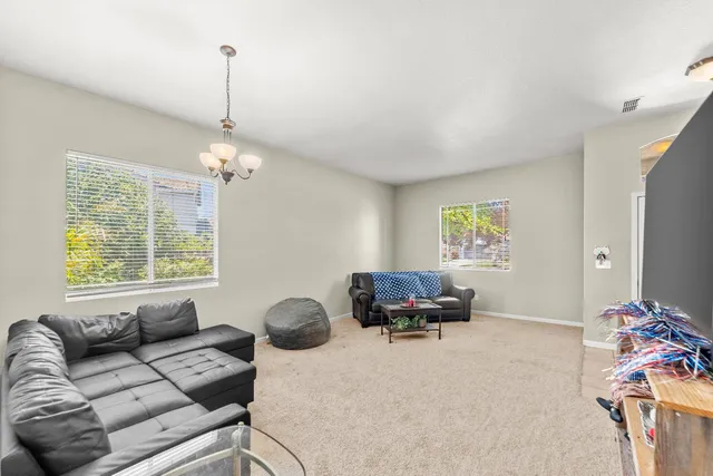 a living room with furniture and a chandelier