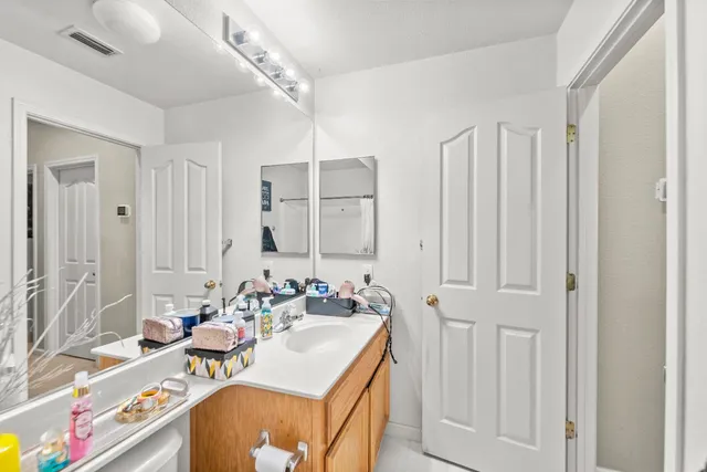a en suite bathroom with a sink double vanity and a mirror