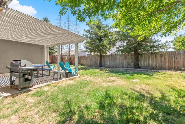 a swimming pool with outdoor seating and yard