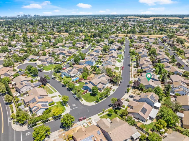 an aerial view of residential houses with outdoor space