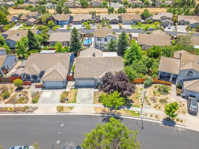 an aerial view of a house with a yard and garden
