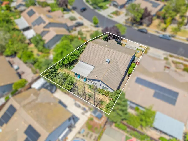 an aerial view of a house with a yard