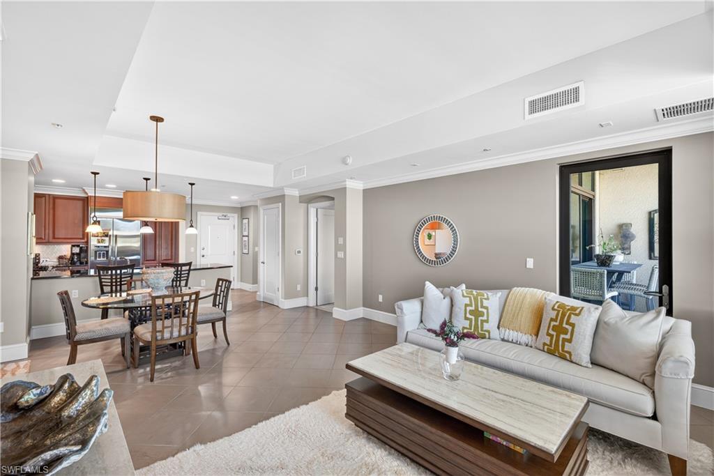 9115 Strada Place, Unit 5504 Naples, FL 34108 - Photo 4 of 22 a living room with furniture and a table
