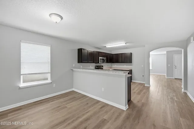 a view of a kitchen with wooden floor and sink