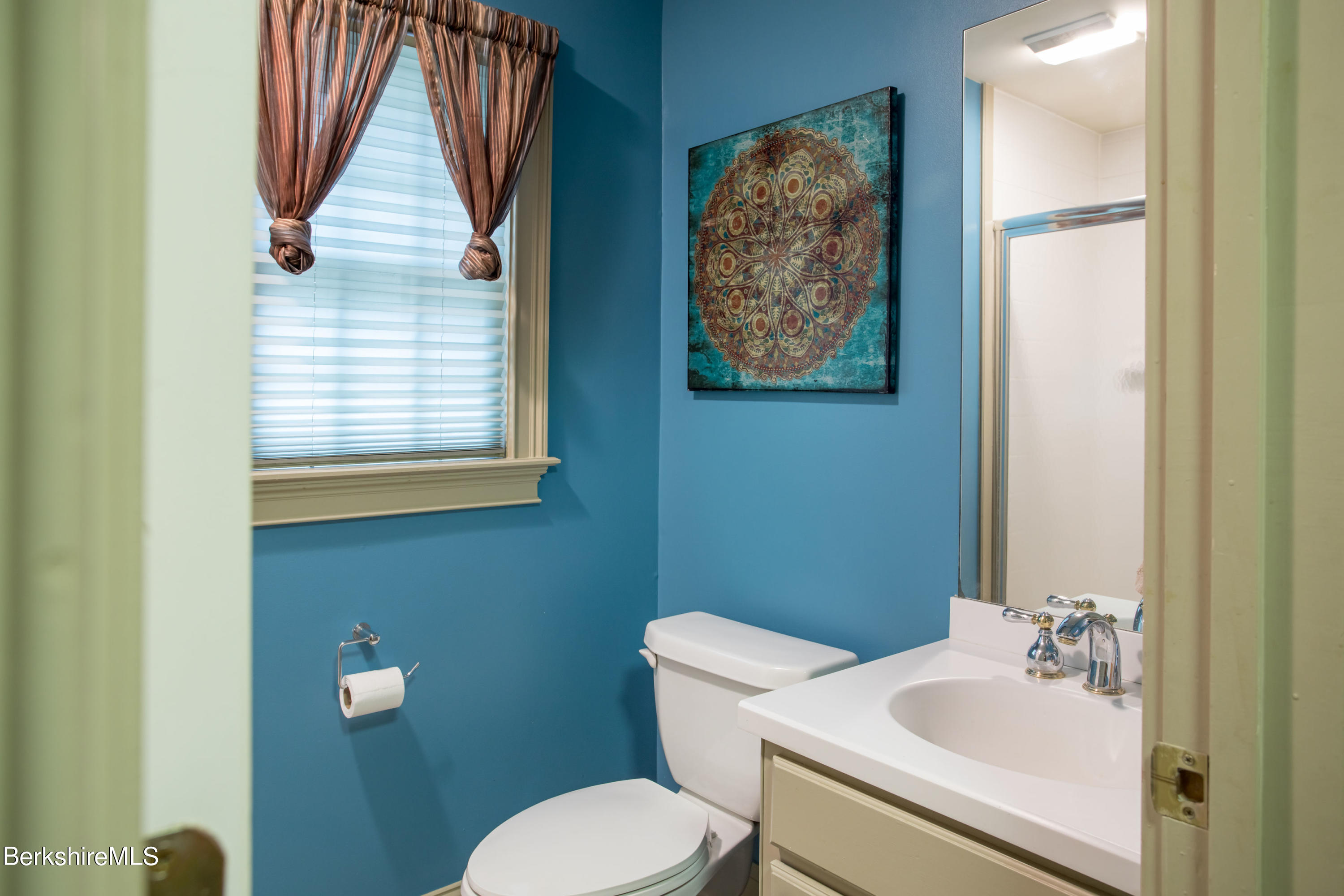 357 Twin Lakes Road Salisbury, CT 06068 - Photo 18 of 31 a bathroom with a toilet sink and mirror