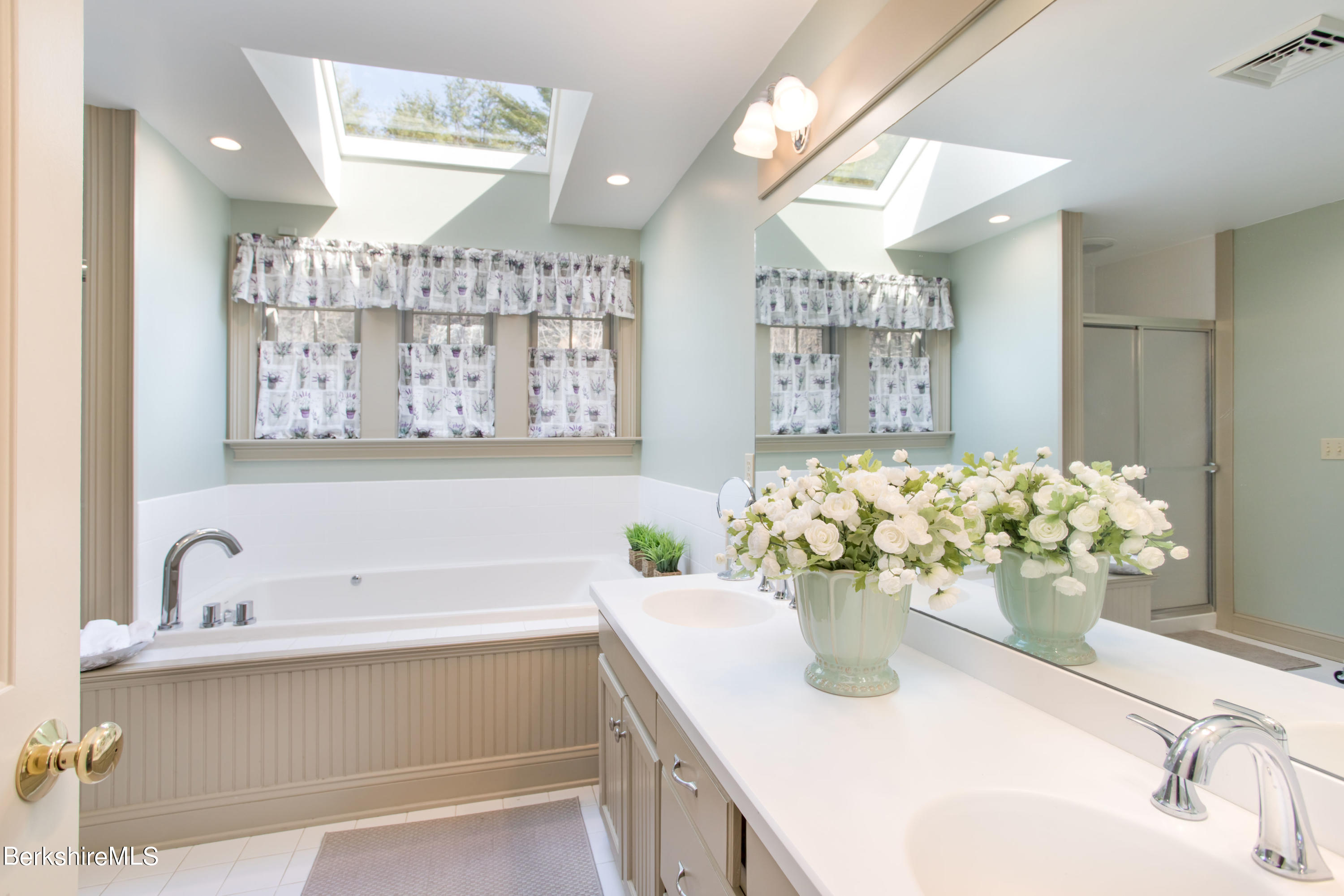 357 Twin Lakes Road Salisbury, CT 06068 - Photo 27 of 31 a bathroom with a sink mirror and a bathtub