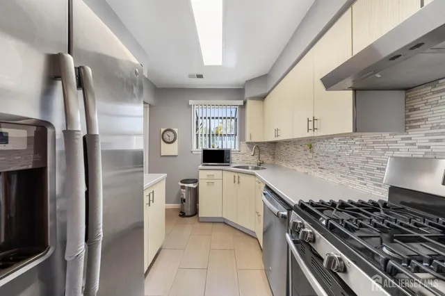 a kitchen with a stove and a refrigerator
