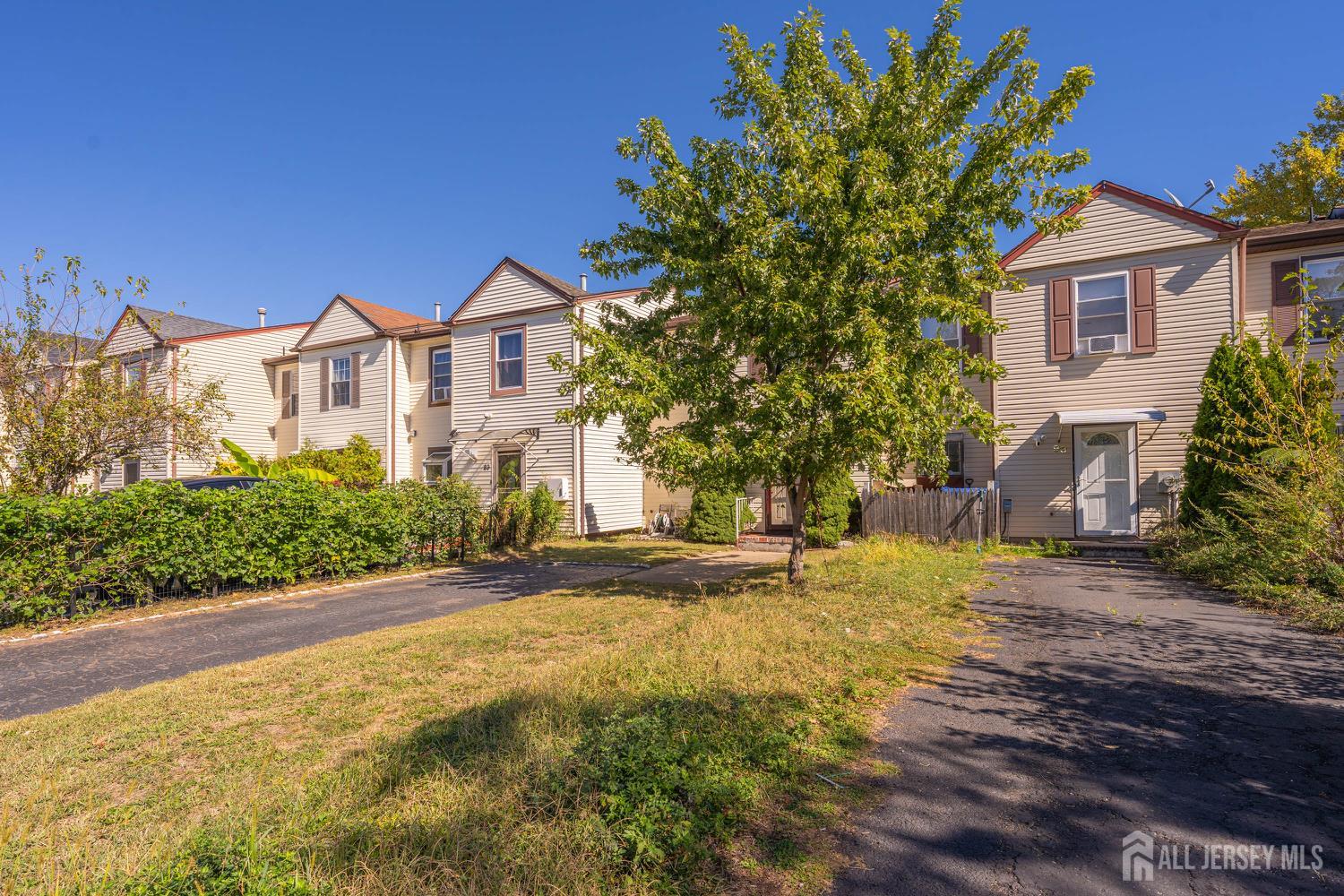 91 Redbud Road Piscataway, NJ 08854 - Photo 19 of 22 a front view of a house with a yard and garage