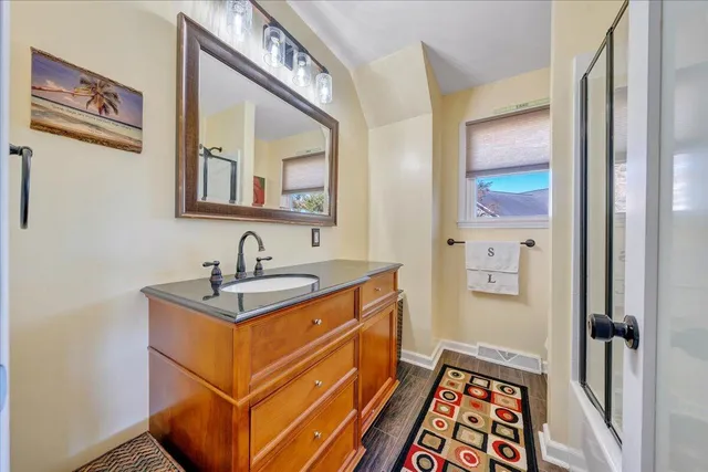 a bedroom with furniture and wooden floor