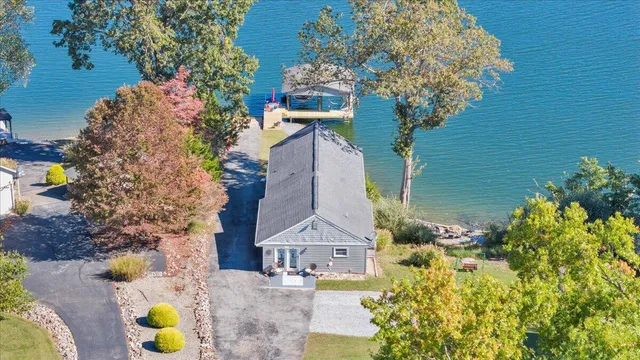 a house view with swimming pool and trees in the background