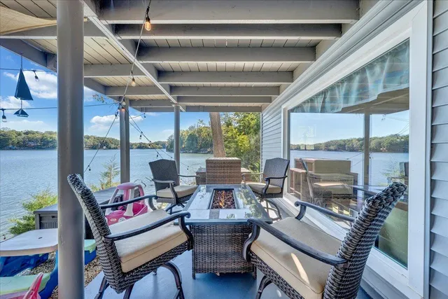 a view of a lake with a table and chairs