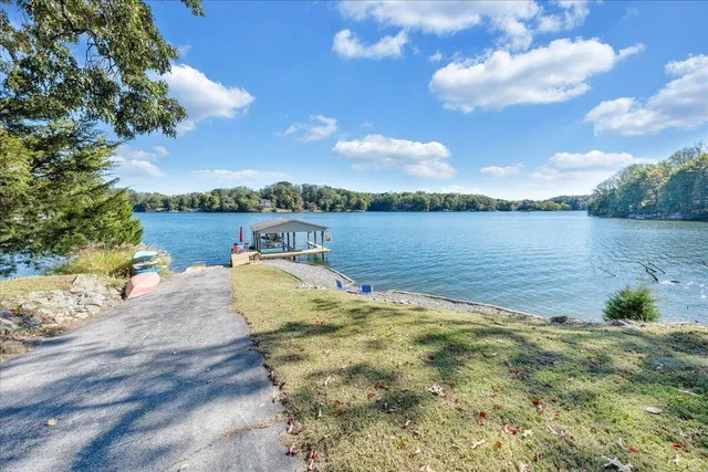 a living room with furniture a rug and a floor to ceiling window