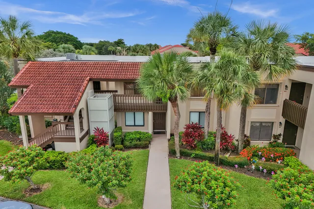 an aerial view of residential houses with outdoor space and street view