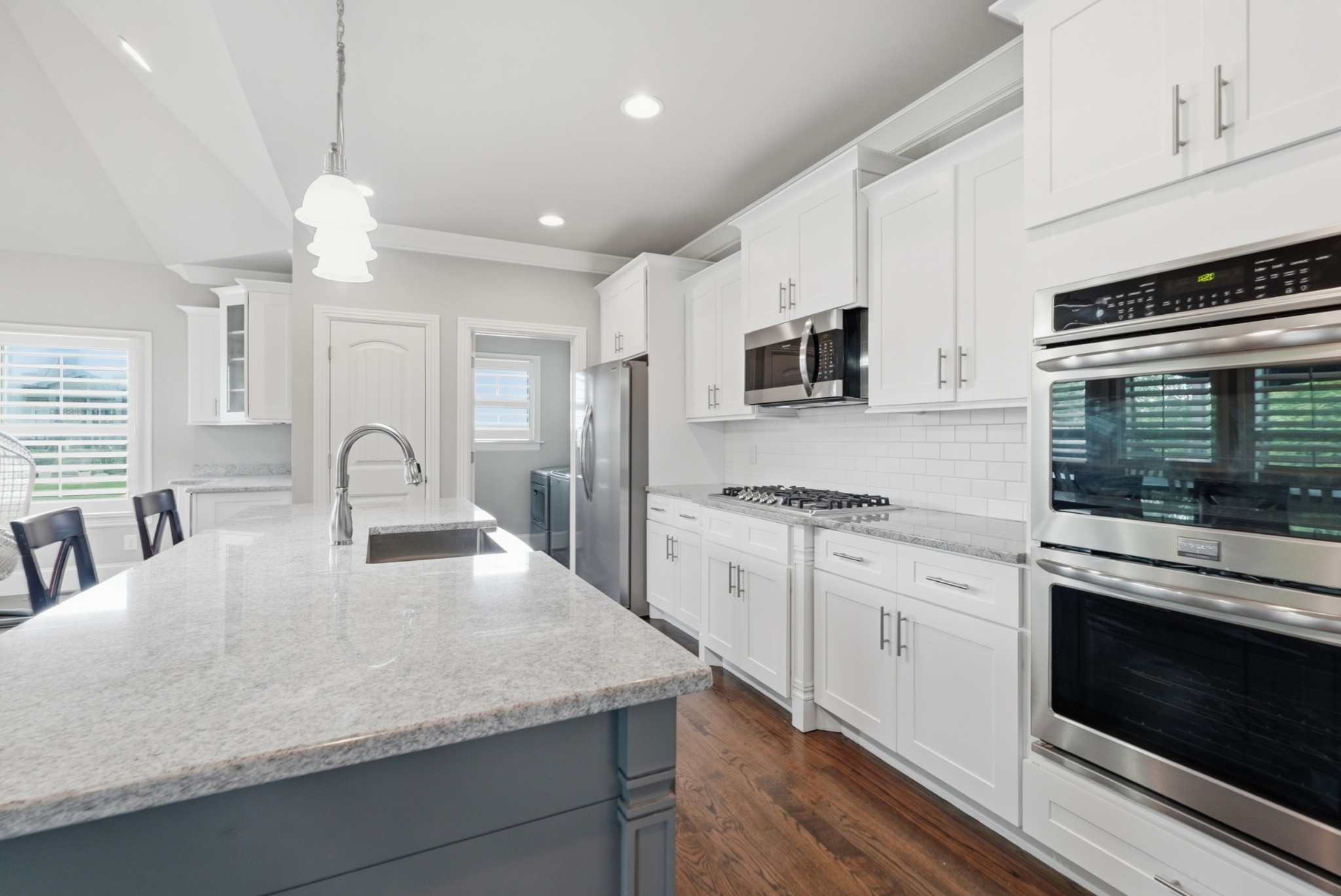 6000 Wallaby Court Spring Hill, TN 37174 - Photo 19 of 57 a large kitchen with granite countertop a stove a sink a refrigerator and a microwave