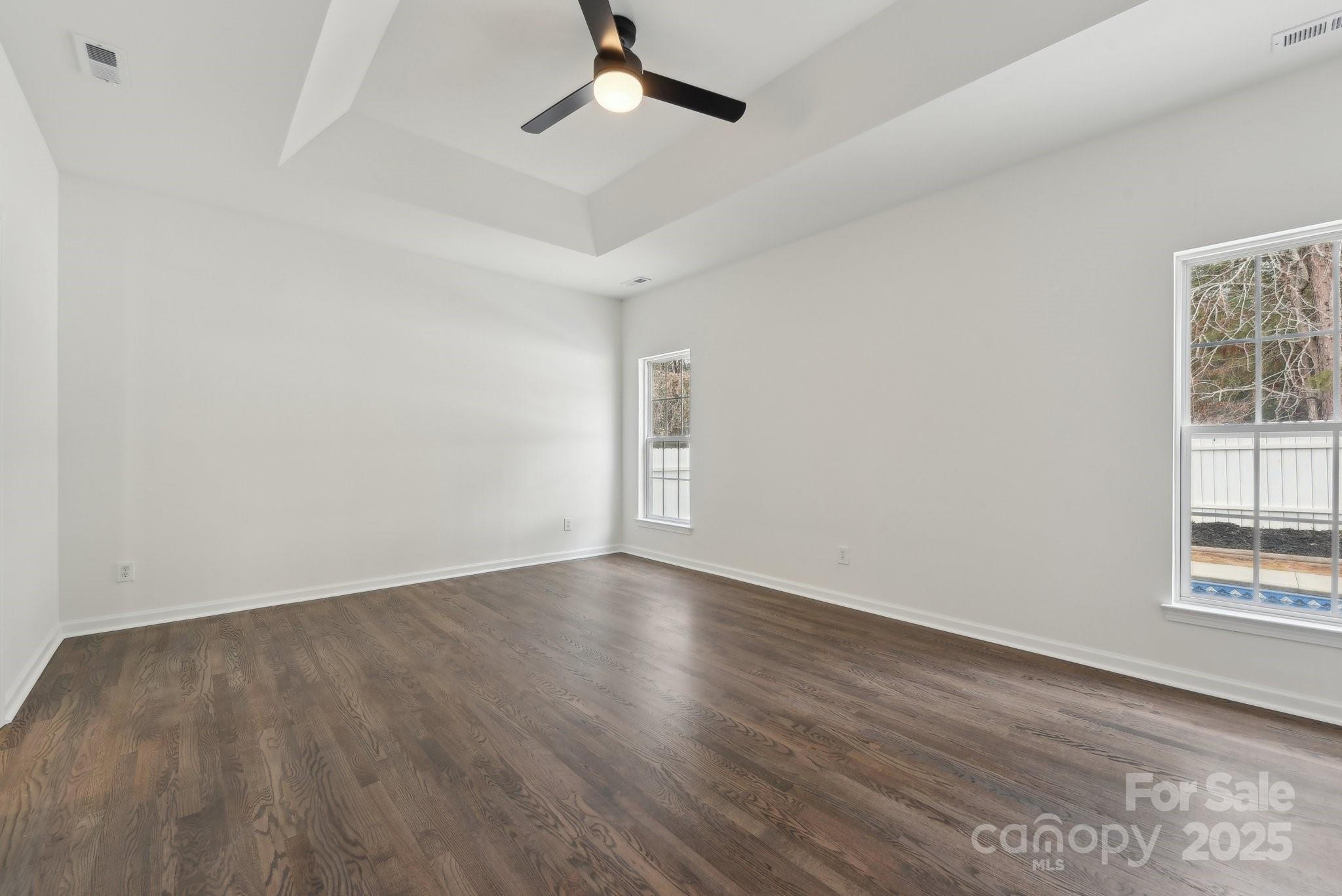 529 Veloce Trail Fort Mill, SC 29715 - Photo 11 of 40 an empty room with wooden floor cabinet and windows