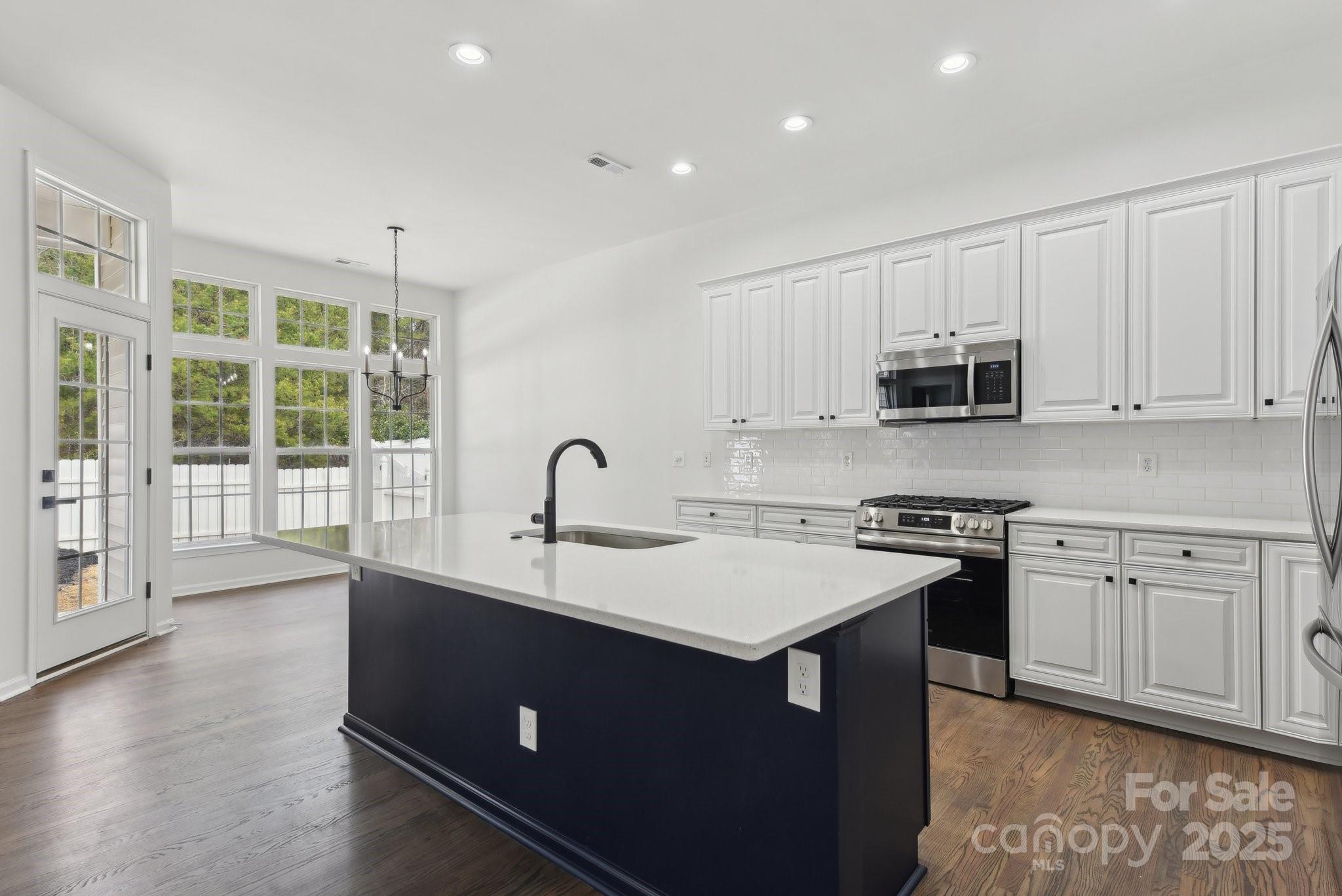 529 Veloce Trail Fort Mill, SC 29715 - Photo 19 of 40 a kitchen with stainless steel appliances granite countertop a sink stove and cabinets