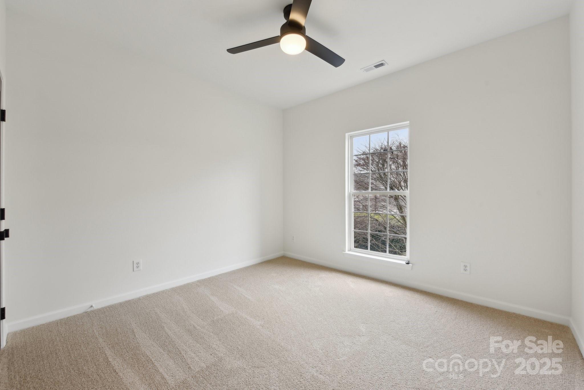 529 Veloce Trail Fort Mill, SC 29715 - Photo 30 of 40 an empty room with a window and a ceiling fan