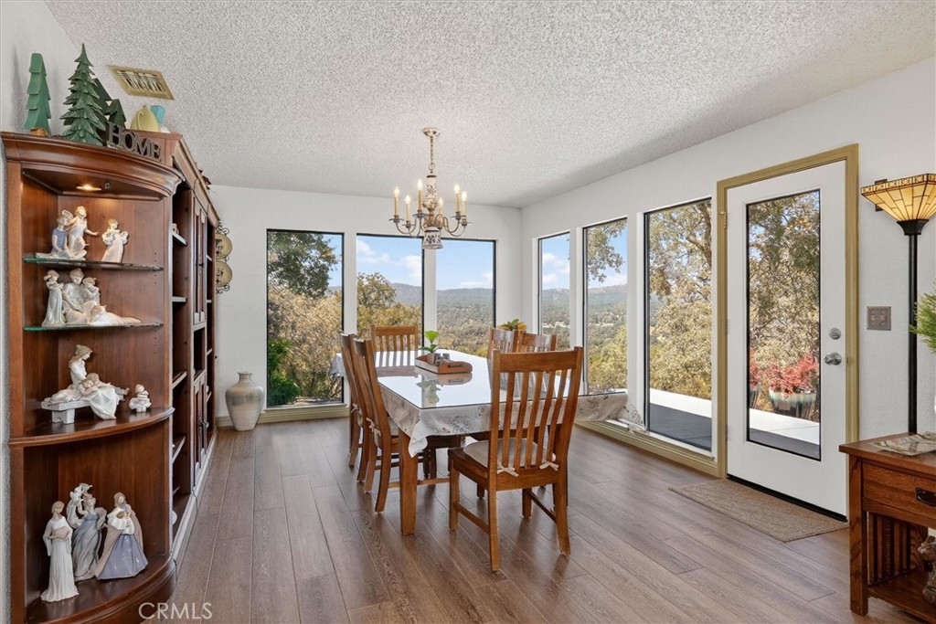 4870 Streeter Mountain Road Mariposa, CA 95338 - Photo 12 of 45 a view of a dining room with furniture window and wooden floor