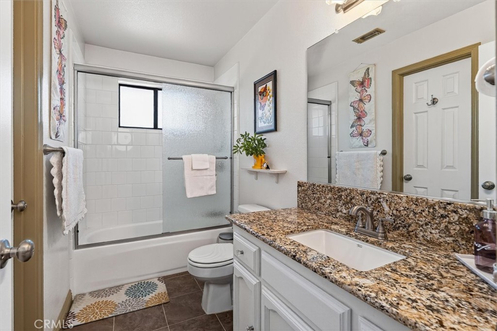 4870 Streeter Mountain Road Mariposa, CA 95338 - Photo 26 of 45 a spacious bathroom with a granite countertop sink and a mirror