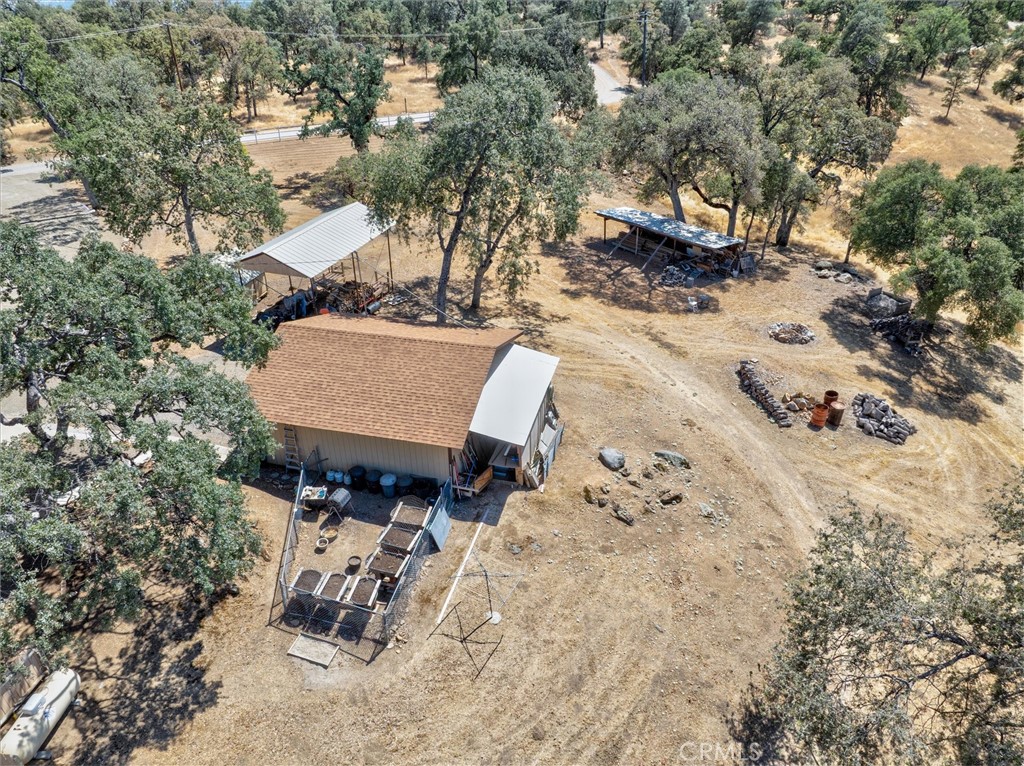 4870 Streeter Mountain Road Mariposa, CA 95338 - Photo 42 of 45 a view of a backyard with table and chairs with a fire pit and large trees