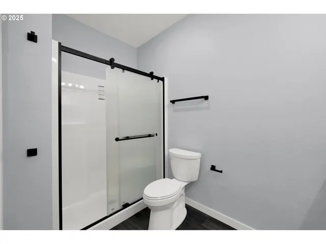 a bathroom with a toilet and a shower