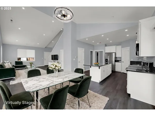 a large kitchen with a table and chairs