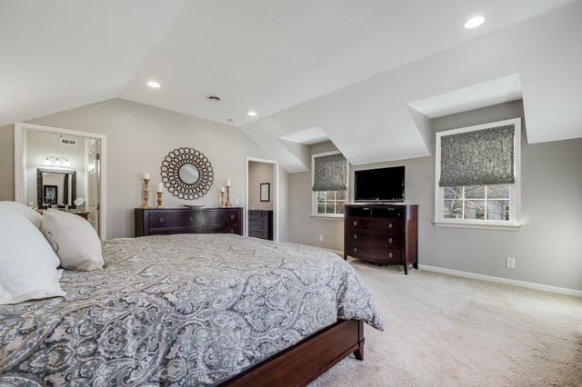 a bedroom with a large bed and a flat screen tv