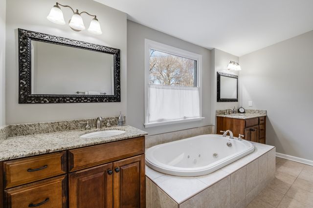 a bathroom with a sink a mirror and a bathtub