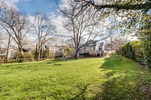 a big yard with large trees