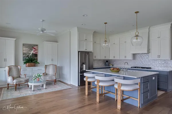 a view of kitchen with cabinets table and chairs