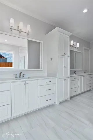 a spacious bathroom with a double vanity sink and a mirror