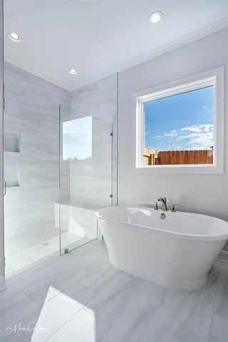 a bathroom with a white tub and shower