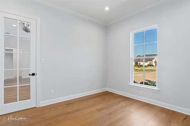 an empty room with windows and closet