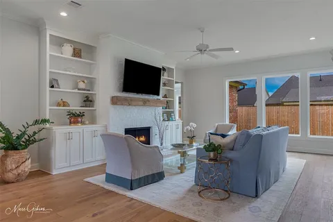 a living room with furniture a flat screen tv and a fireplace