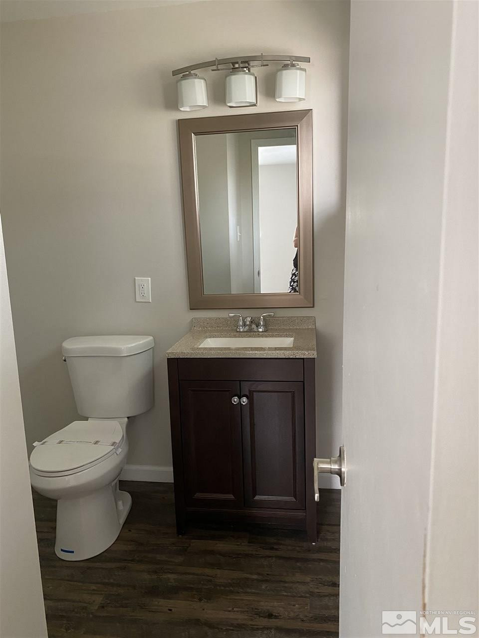 1365 Stardust Street, Unit 3 Reno, NV 89503 - Photo 5 of 9 a bathroom with a toilet sink and mirror