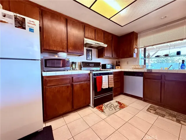 a view of a hallway with wooden shelves