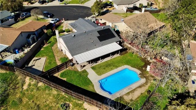 an aerial view of a house with a garden and swimming pool