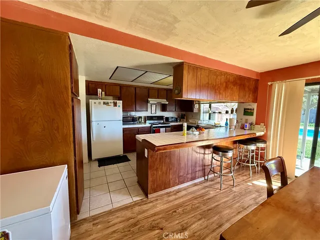 a large kitchen with stainless steel appliances granite countertop a stove a sink dishwasher and cabinets