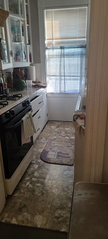 229 Cory Street Fall River, MA 02720 - Photo 12 of 30 a view of a kitchen that has a sink window and stainless steel appliances