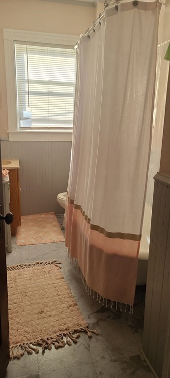 229 Cory Street Fall River, MA 02720 - Photo 17 of 30 a bathroom with a window and a bath tub