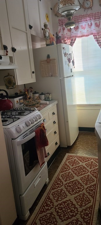 229 Cory Street Fall River, MA 02720 - Photo 2 of 30 a stove top oven sitting inside of a kitchen