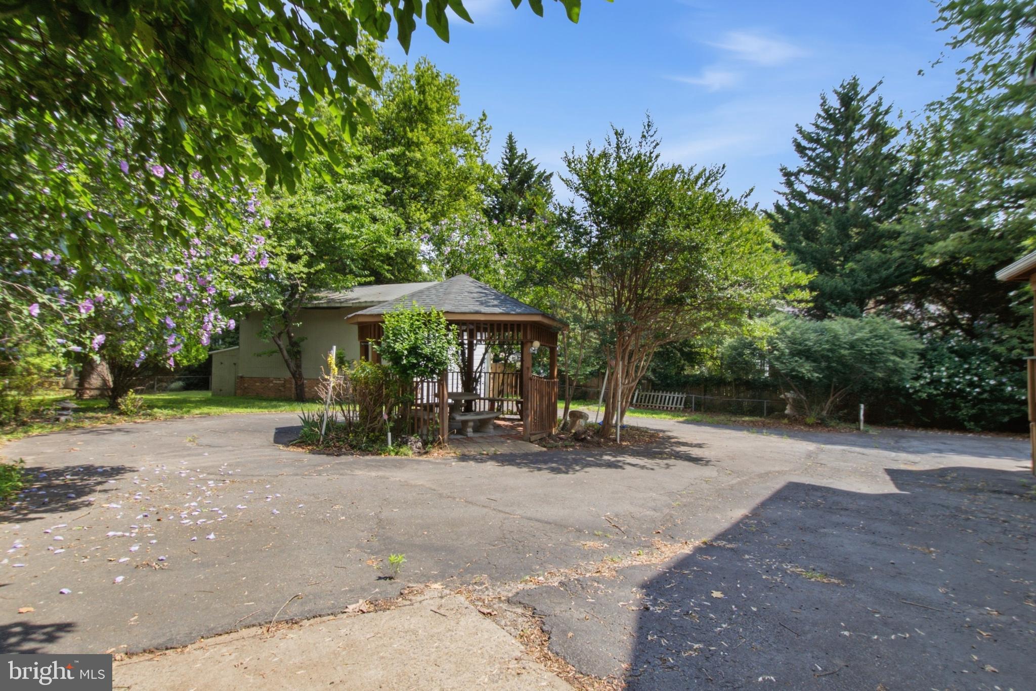 511 Malcolm Road Northwest Vienna, VA 22180 - Photo 7 of 16 a view of patio with a table and chairs under an umbrella