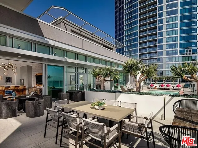 a view of a building with furniture and outdoor seating