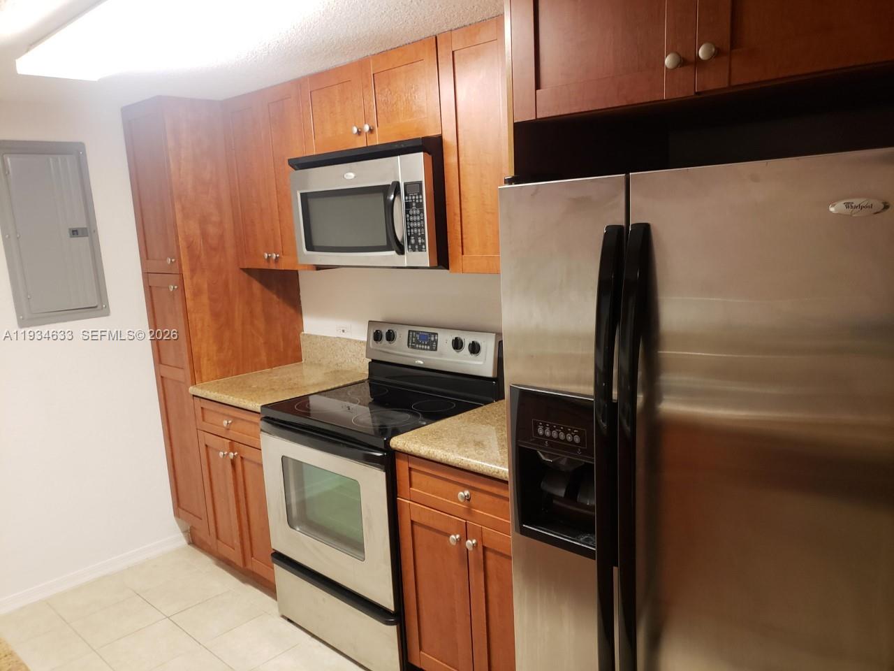 36 Northwest 6th Avenue, Unit 906 Miami, FL 33128 - Photo 3 of 37 a kitchen with stainless steel appliances granite countertop a refrigerator and a stove