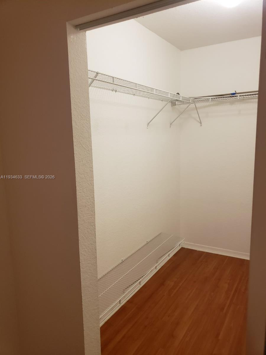 36 Northwest 6th Avenue, Unit 906 Miami, FL 33128 - Photo 7 of 37 a view of a room with racks on the wall