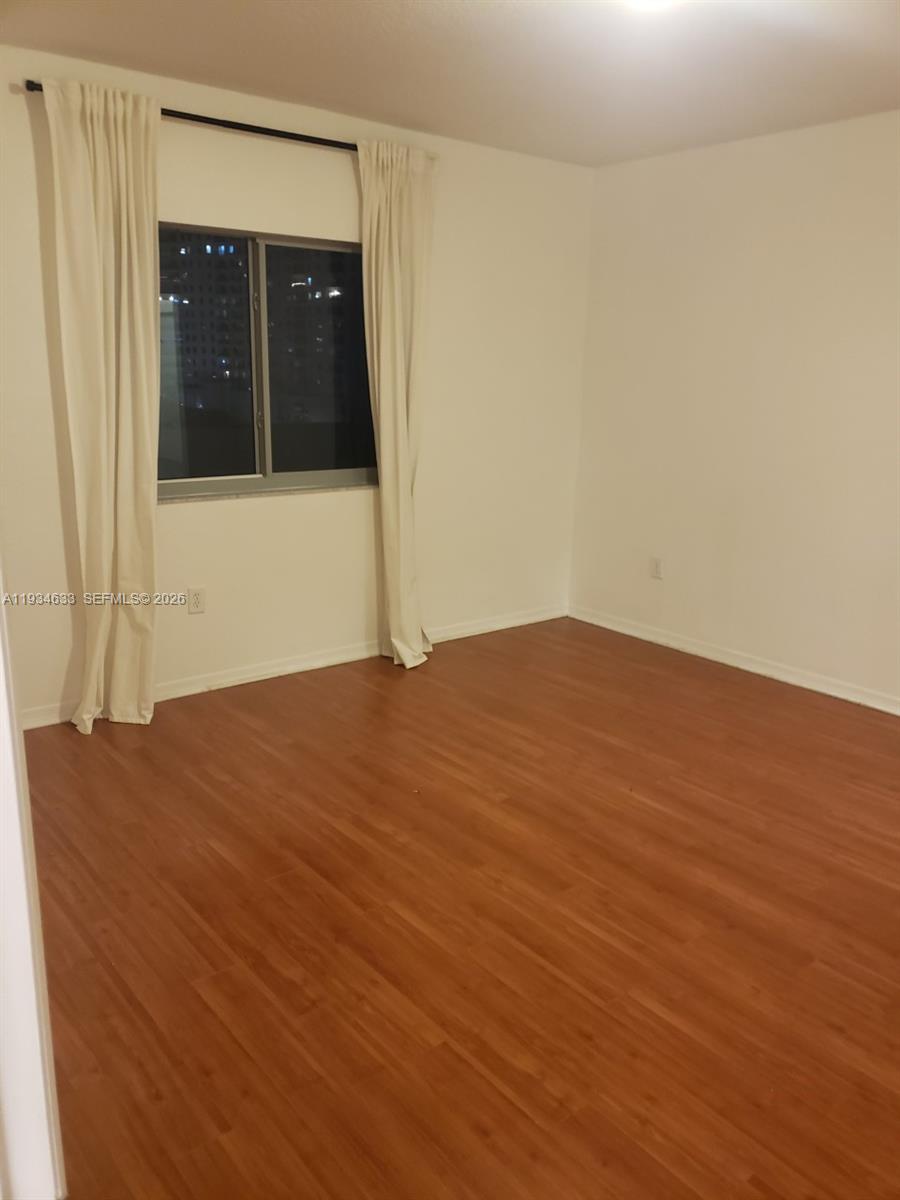 36 Northwest 6th Avenue, Unit 906 Miami, FL 33128 - Photo 8 of 37 a view of an empty room with wooden floor