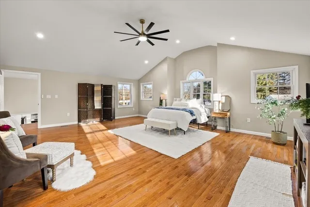 a spacious bedroom with a large bed and a window