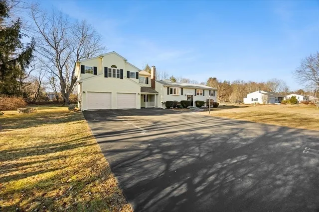 a kitchen with stainless steel appliances kitchen island granite countertop a dining table chairs and sink