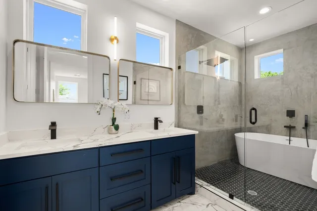 a bathroom with a bathtub sink and mirror