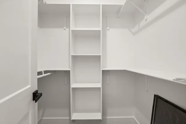 a bathroom with a granite countertop sink and white cabinets
